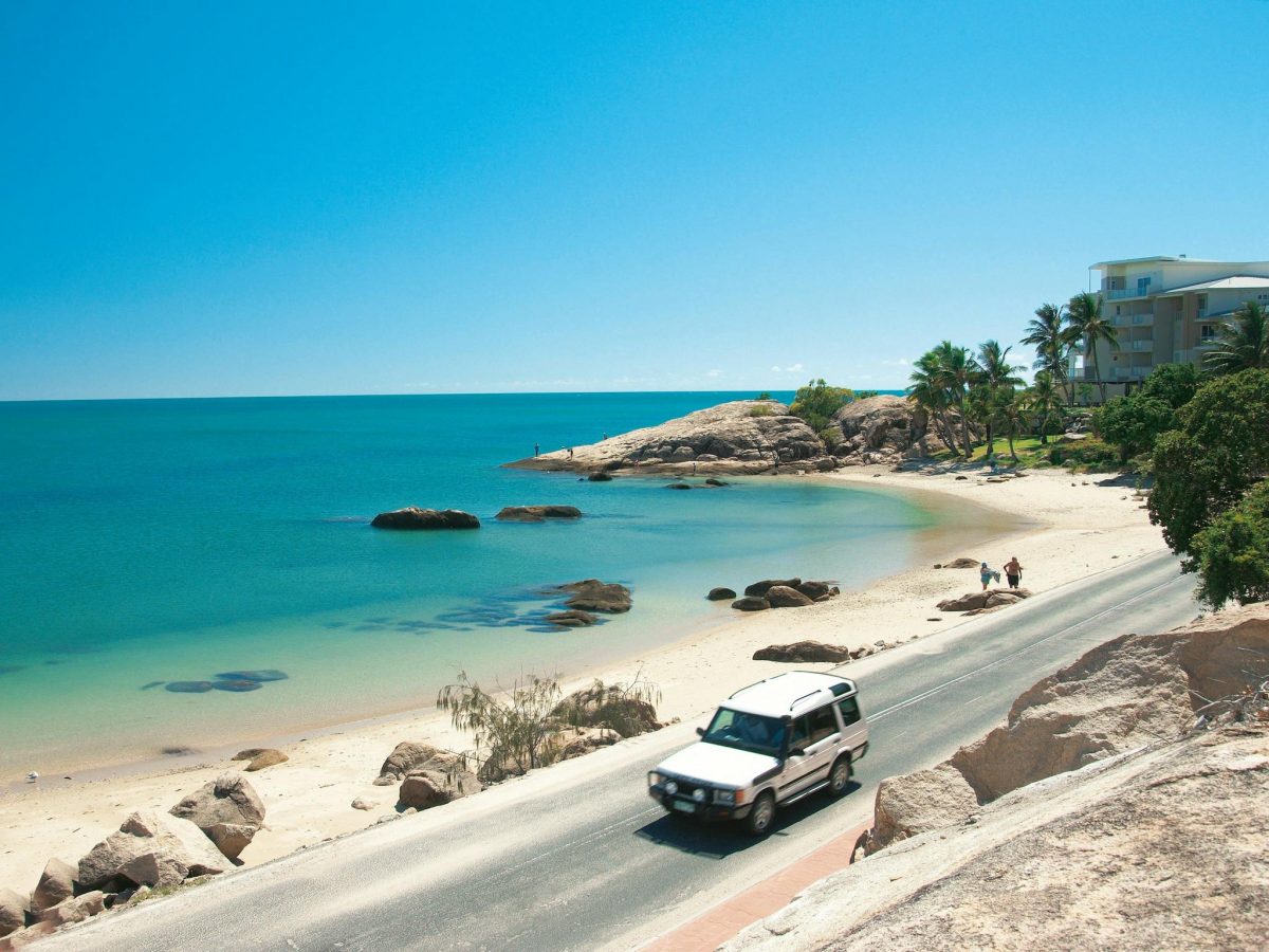 a car driving along a coastal road