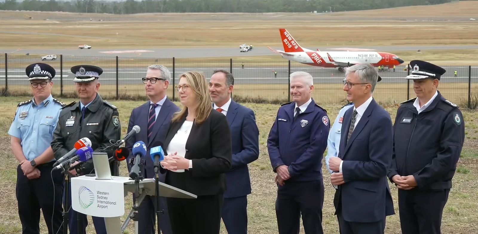 dignitaries at an airport media event