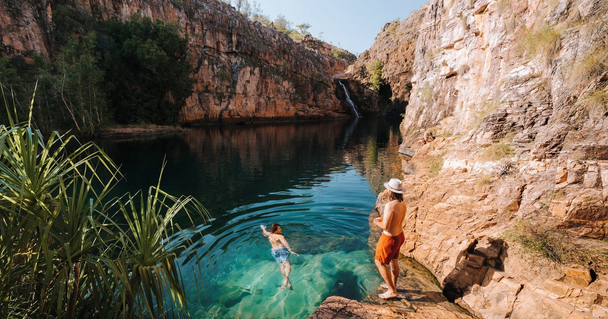 two people at a swimming spot in a remote area