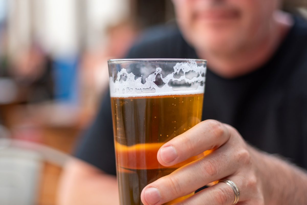 man holding a glass of beer