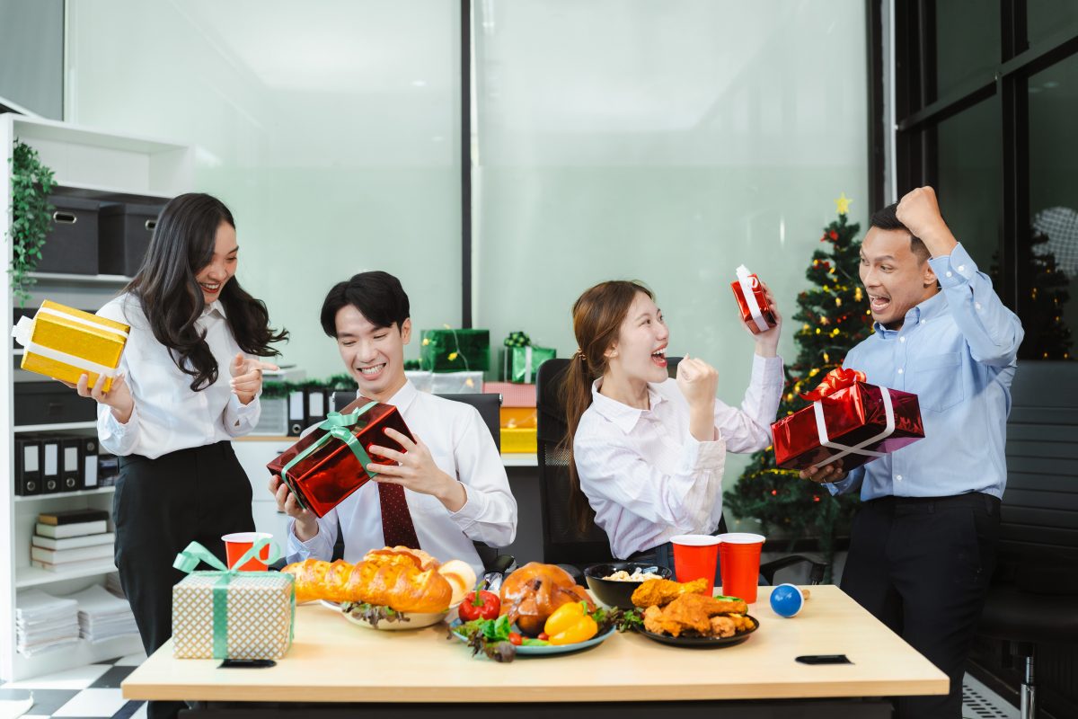 Young people, celebrating together and gift exchange at Christmas