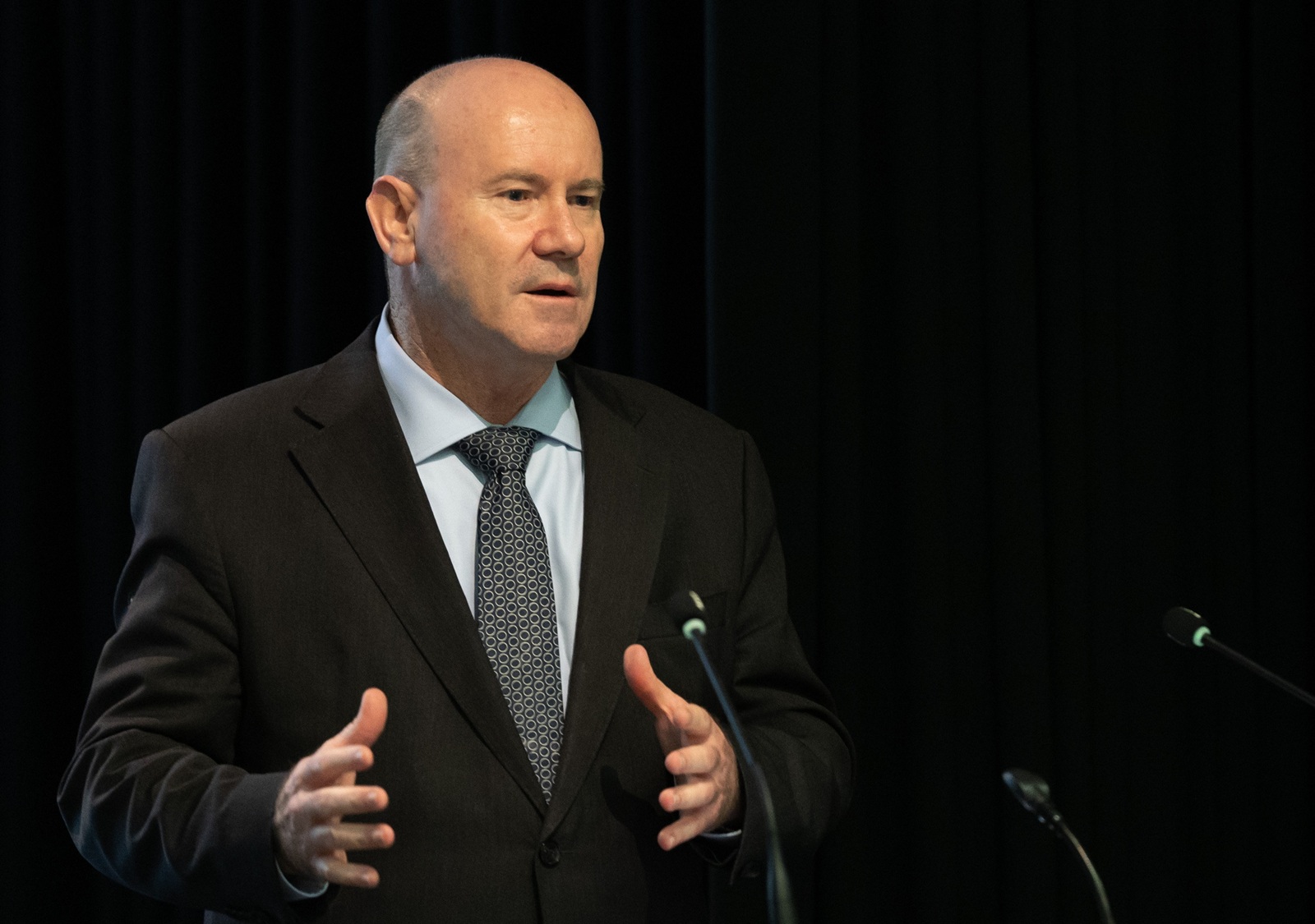 man in a suit giving a public address