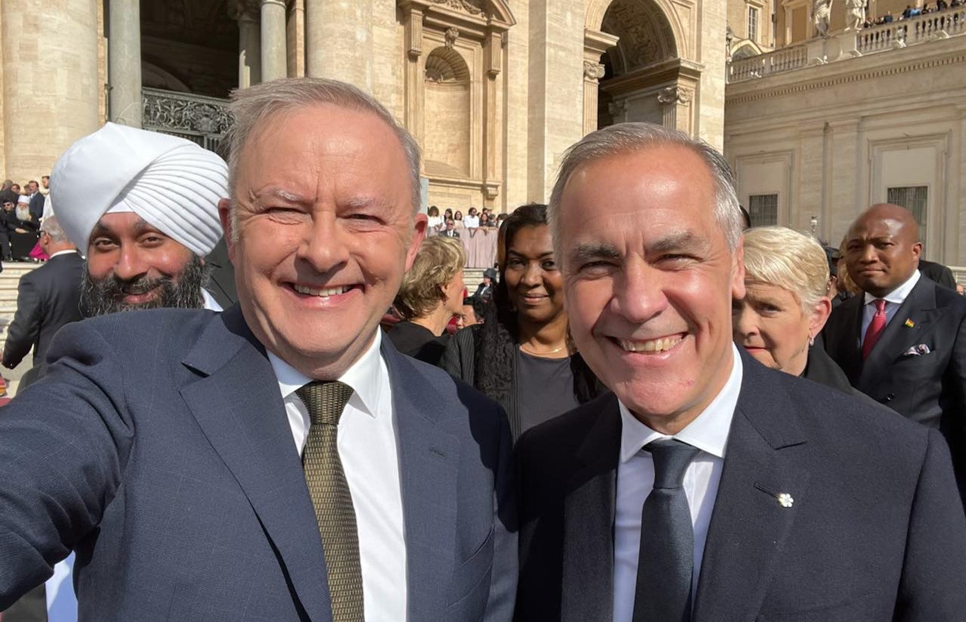 selfie of two smiling men in suits