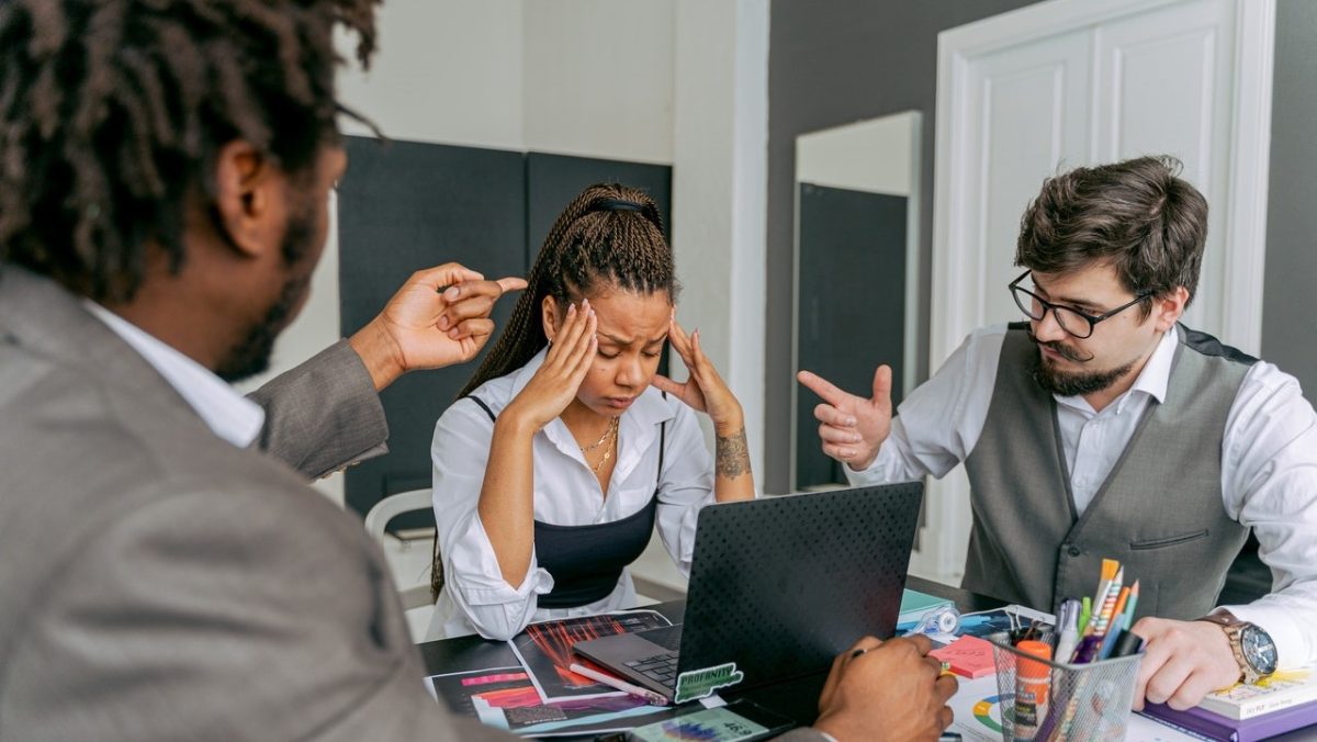 Men argue around a distressed woman 