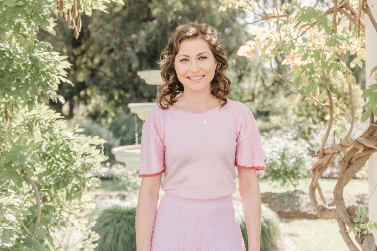 Woman in pink dress smiling