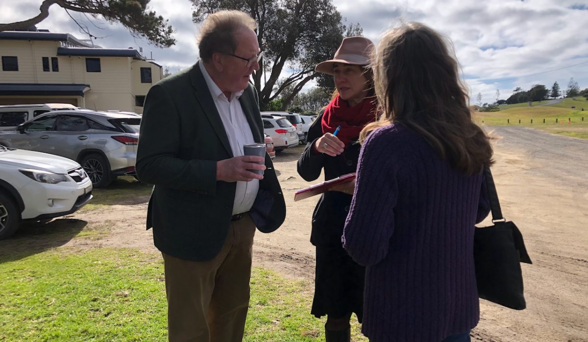 a man and two women in conversation