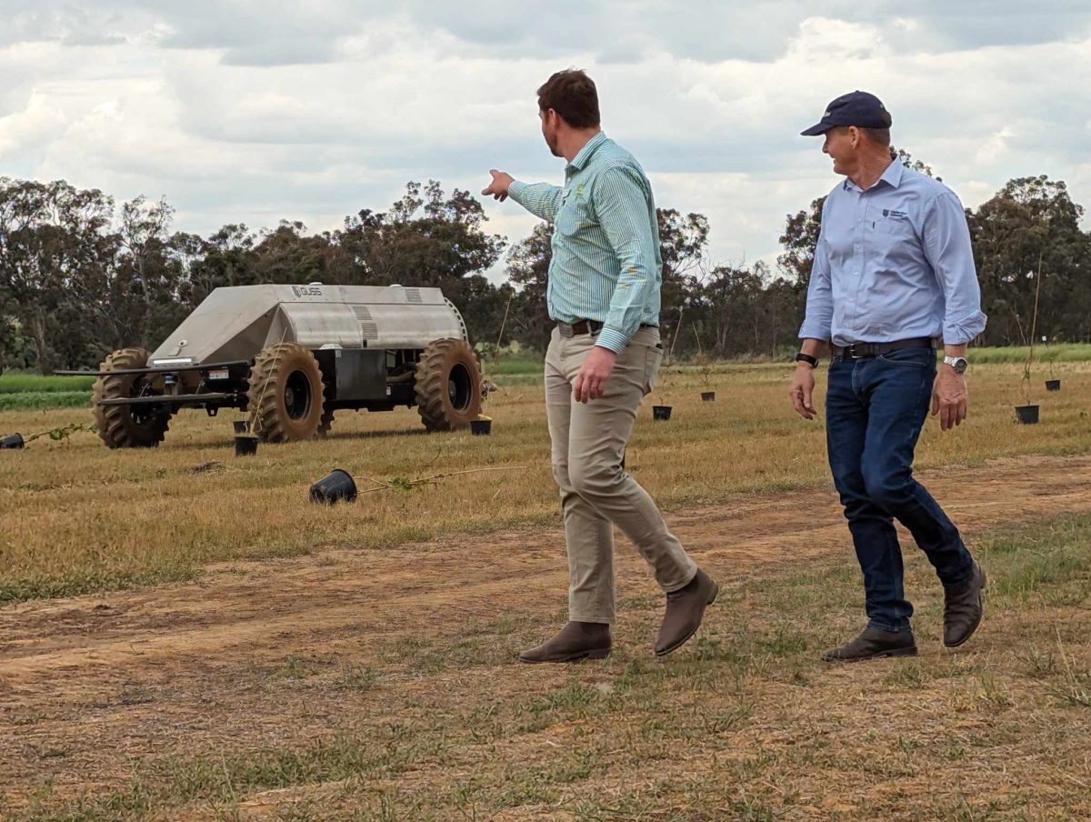 two men looking at farm technology on site
