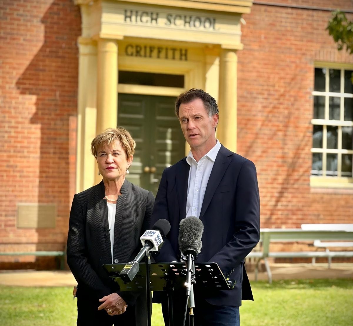 Premier and Helen in front of school
